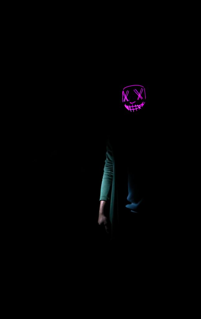 Enigmatic Neon Purple Mask Wallpaper: Edgy, Striking Background
