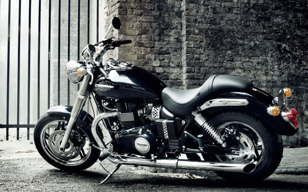 Enjoy the Ride! Sleek Black Triumph Motorcycle Wallpaper Background
