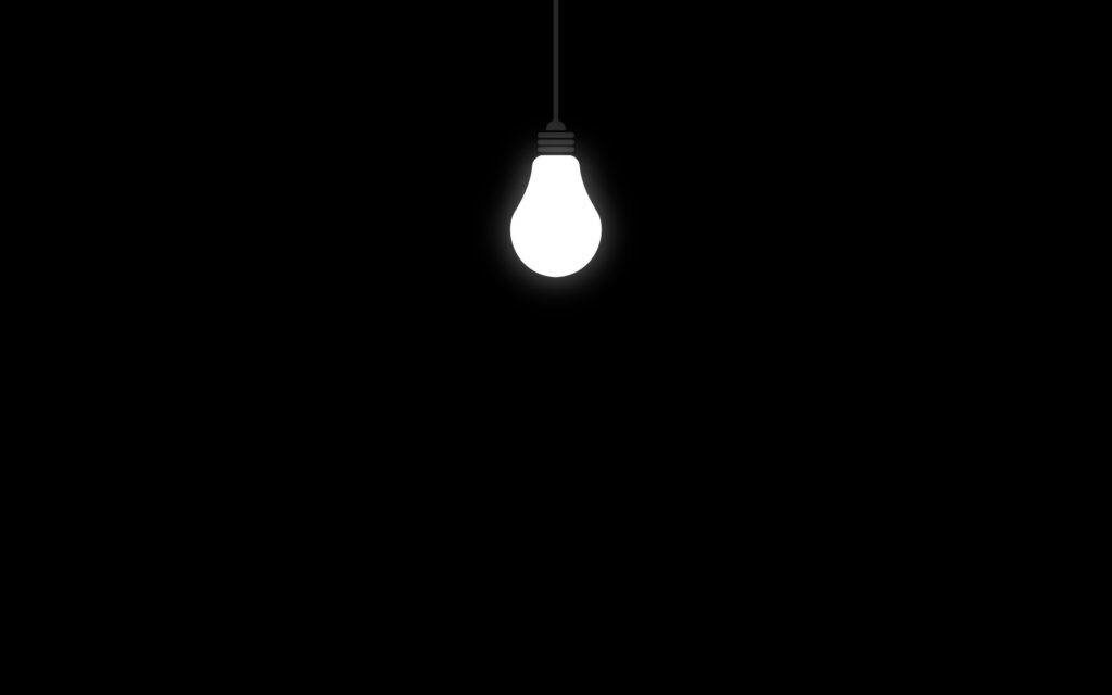 The Illuminated Ceiling: A Minimalistic Light Bulb in a Black Void Wallpaper