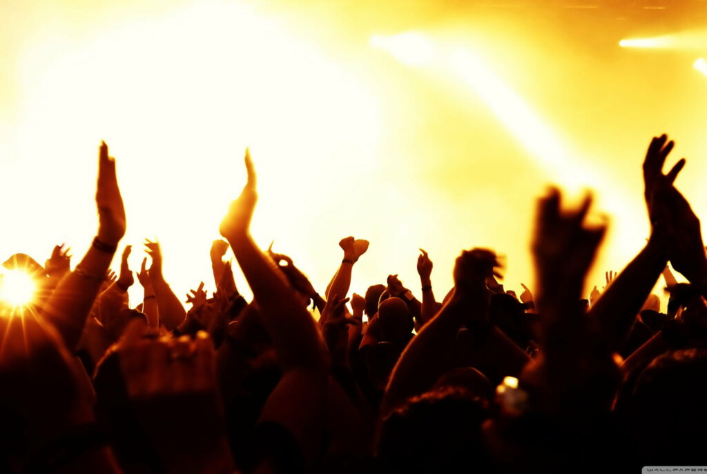 Exuberant Joy: Vibrant Concert Lights Illuminate a Crowd in a Captivating HD Wallpaper Background