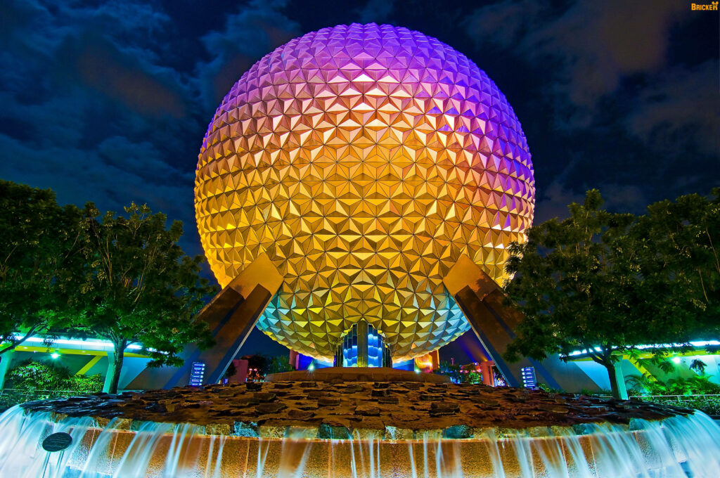 Epcot geodesic sphere glowing gold purple lights with fountain at night vibrant wallpaper background