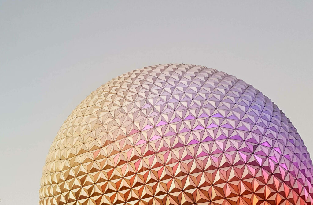 Epcot Globe wallpaper with pink gold lavender gradient and geometric dome texture background