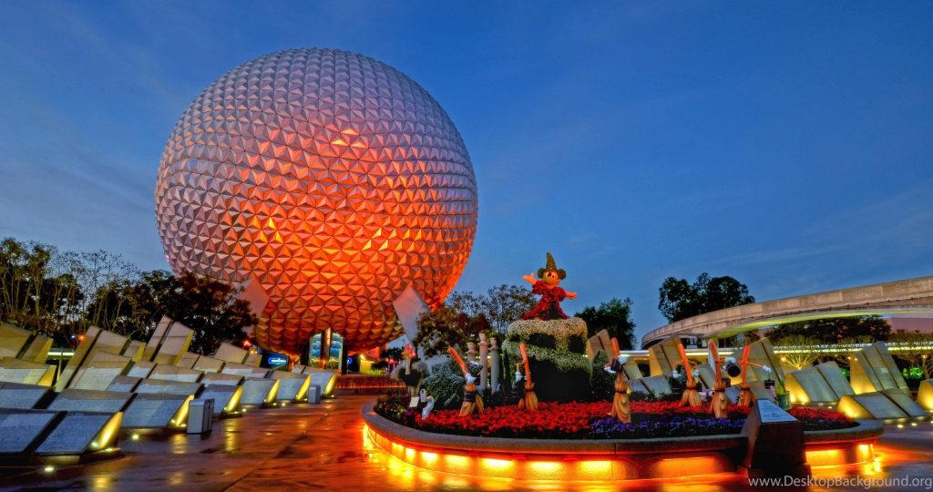 Epcot Spaceship Earth twilight wallpaper with Sorcerer Mickey Fantasia brooms topiary display
