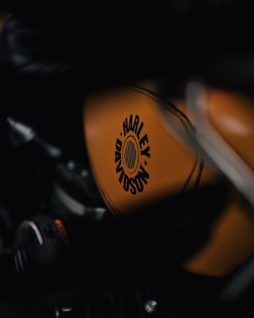 Close-up of Harley-Davidson IRON burnt orange gas tank on moody high-contrast motorcycle wallpaper