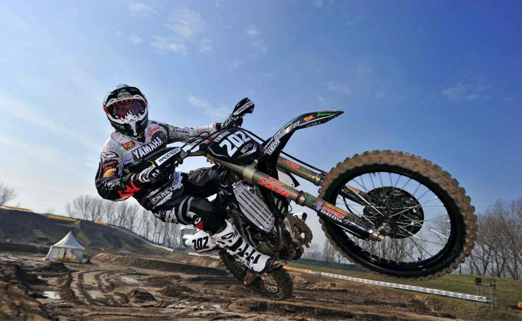Thrilling Mountain Biking Stunt Over Canyon - Wallpaper Background