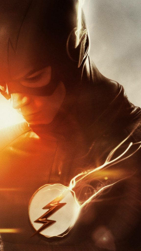 Epic The Flash Wallpaper: Dramatic Pose & Iconic Emblem in Warm Light