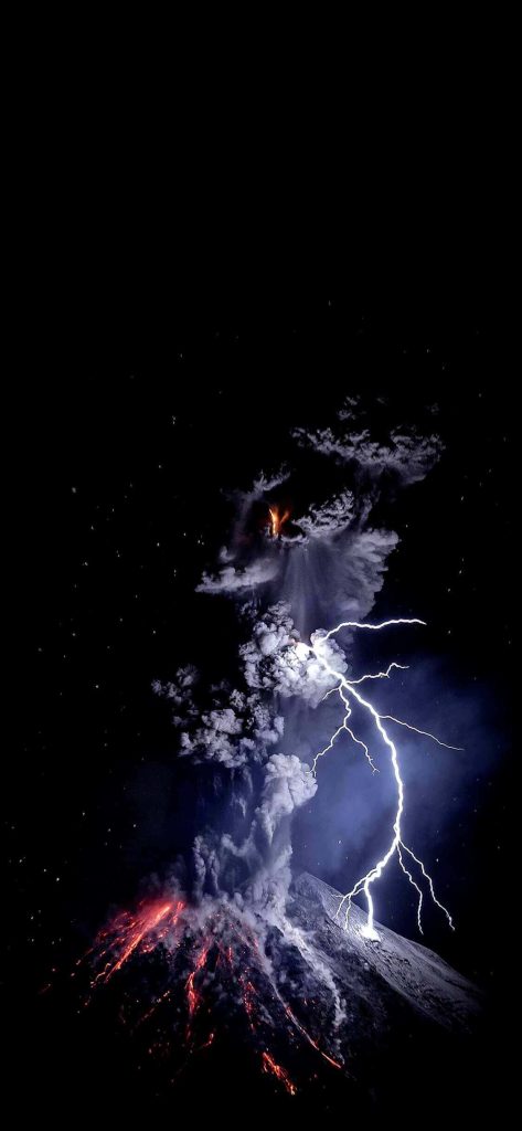 Volcanic eruption with lightning strike glowing lava flows dark ash-filled night sky wallpaper