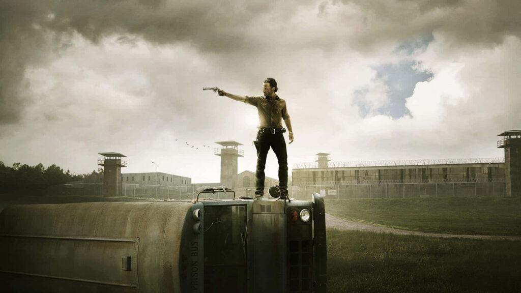 Dramatic Walking Dead Wallpaper: Determined Hero on Overturned Bus