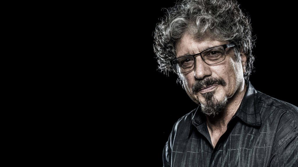 Eric Burdon high contrast studio portrait with curly hair glasses black background wallpaper