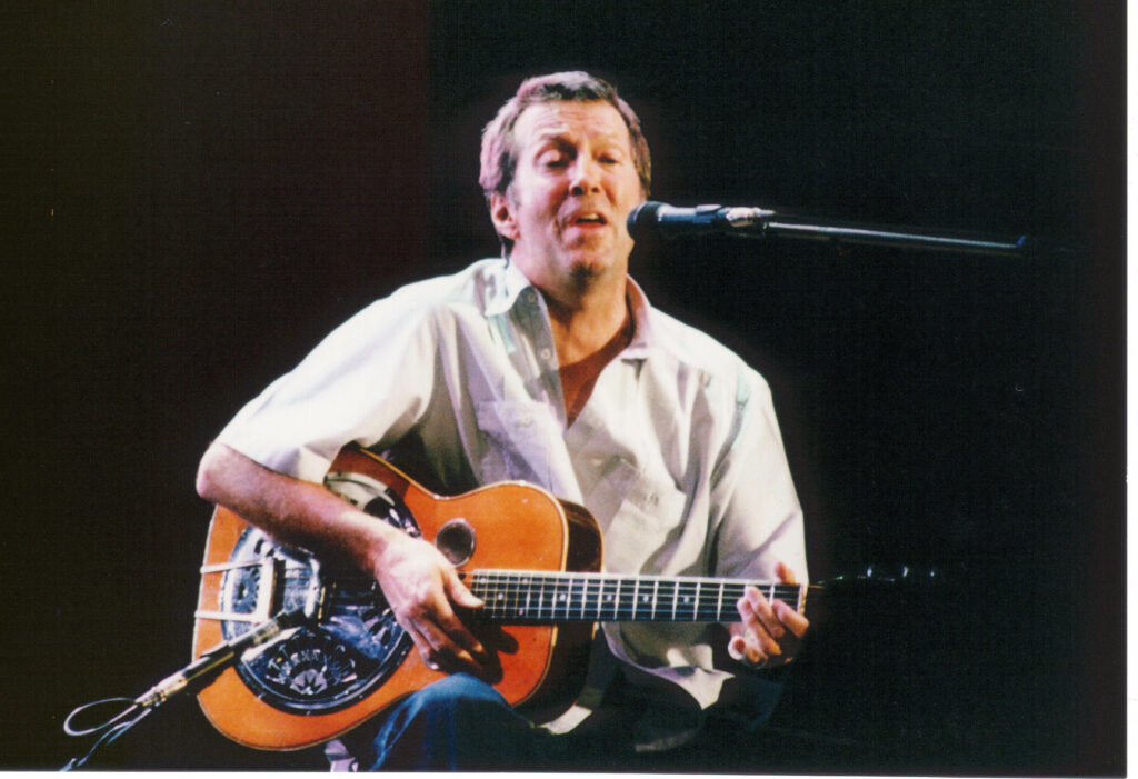 Eric Clapton live acoustic guitar performance spotlight intimate concert blues music wallpaper