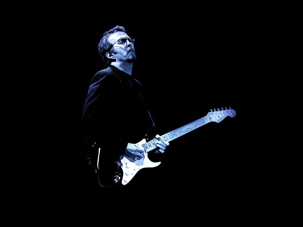 Eric Clapton playing guitar under blue stage lights with dark background iconic music scene Wallpaper