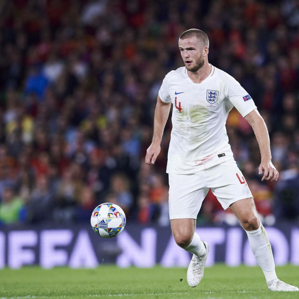 Eric Dier in England football kit preparing to kick ball on stadium pitch showcasing athleticism Wallpaper
