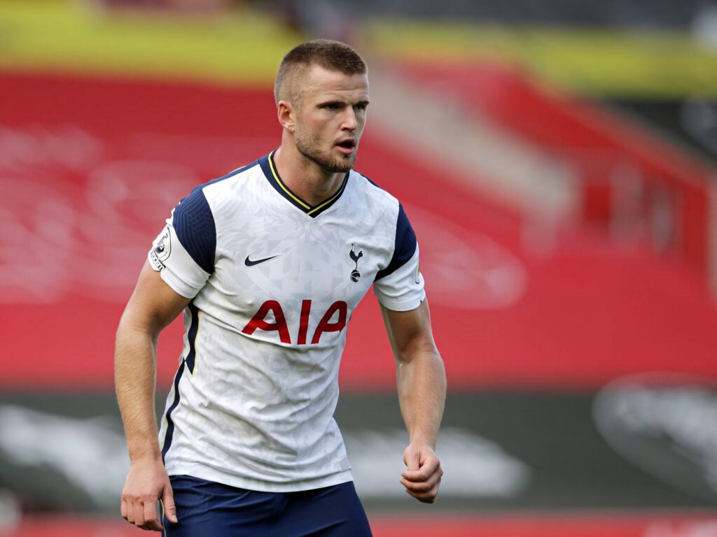 Eric Dier in Tottenham Hotspur kit focused during intense football match in vibrant stadium background Wallpaper