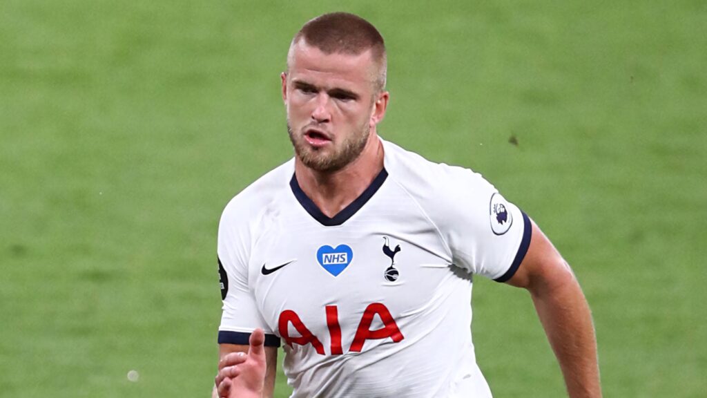 Eric Dier running on green pitch in Tottenham Hotspur kit showing focus and energy wallpaper