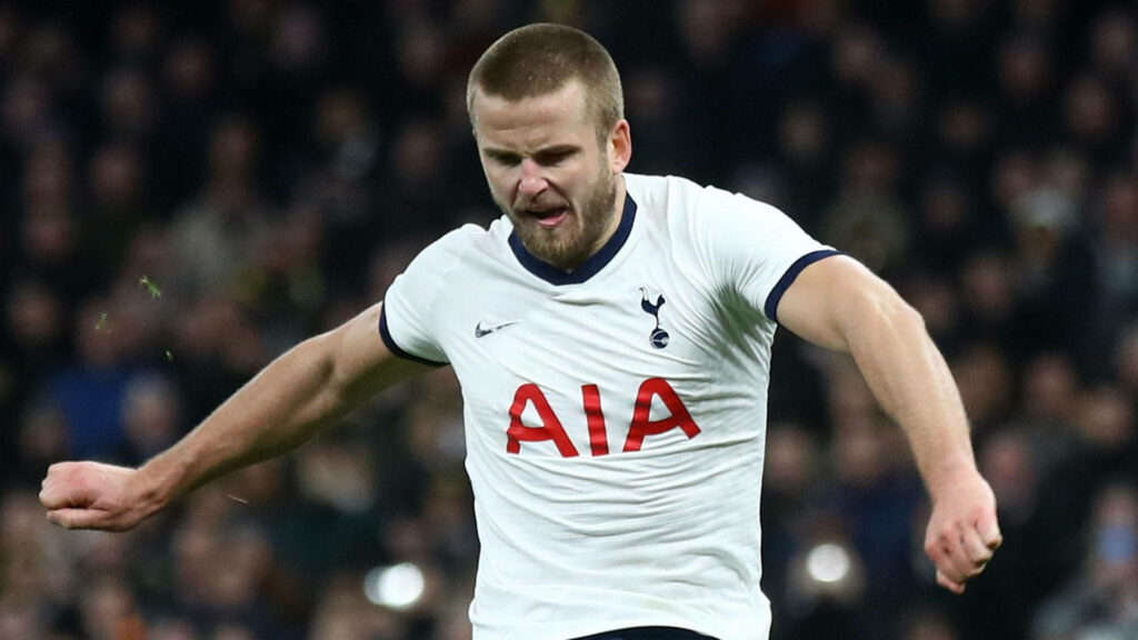 Eric Dier in white Tottenham Hotspur kit in action with focused expression in stadium wallpaper
