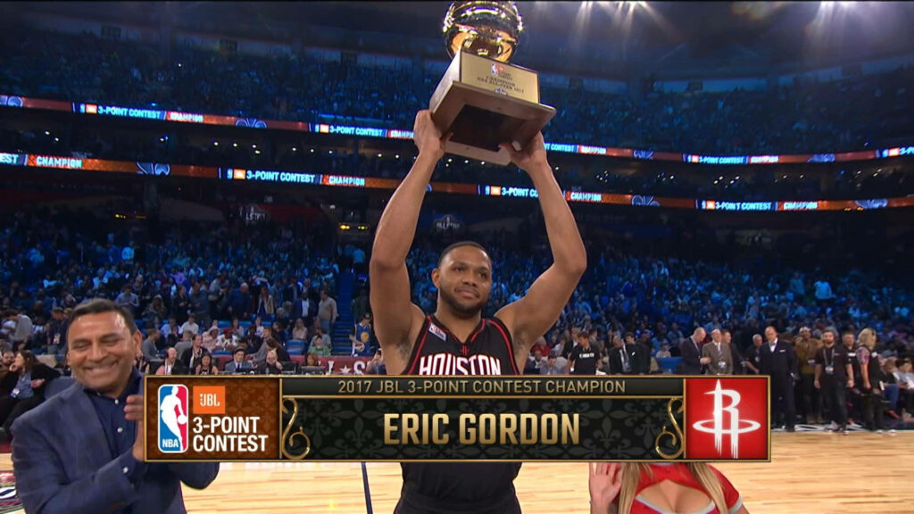 Eric Gordon celebrates 2017 JBL 3-Point Contest win in Houston Rockets jersey with trophy raised Wallpaper