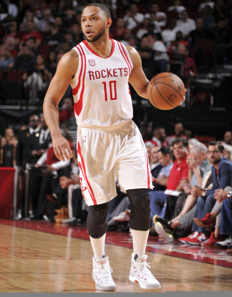 Eric Gordon Houston Rockets white jersey in action intense game dynamic basketball arena wallpaper
