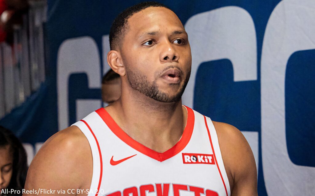 Point Guard Eric Gordon in Houston Rockets jersey courtside intense basketball wallpaper background