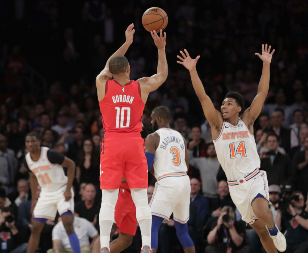 Eric Gordon shoots three-pointer defended by Allonzo Trier in intense Rockets Knicks game action Wallpaper