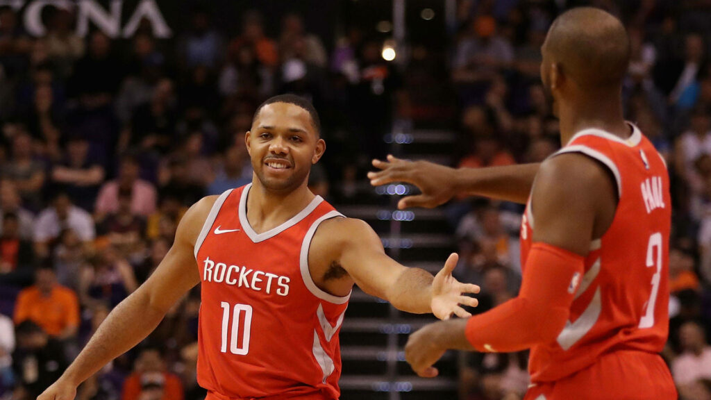 Eric Gordon and Chris Paul in red Houston Rockets jerseys celebrate teamwork on court wallpaper
