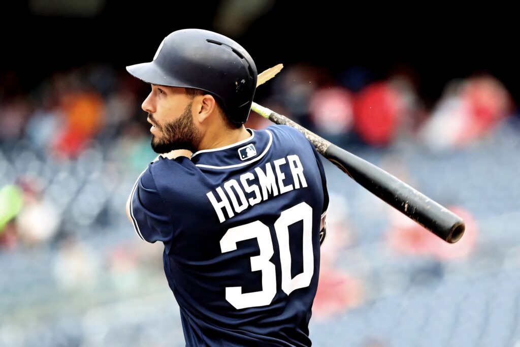 Eric Hosmer in navy blue baseball uniform holding bat with intense game-ready expression wallpaper
