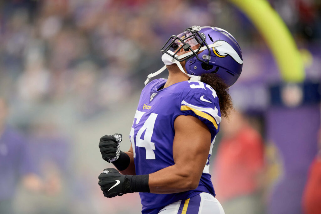 Eric Kendricks Minnesota Vikings linebacker celebrating on field in purple white uniform stadium background Wallpaper