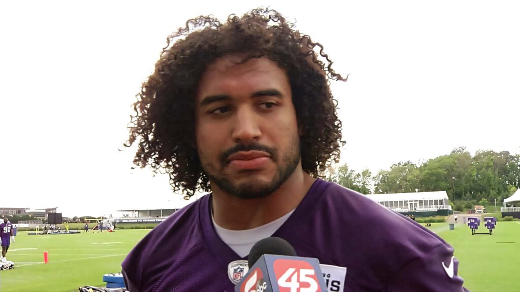 NFL linebacker Eric Kendricks in purple Vikings jersey on green turf during practice session Wallpaper