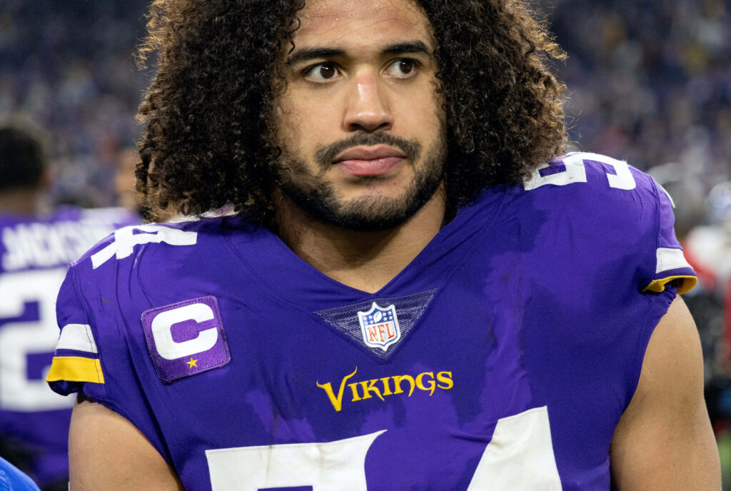 Eric Kendricks focused in Minnesota Vikings purple gold uniform with captain patch number 54 Wallpaper