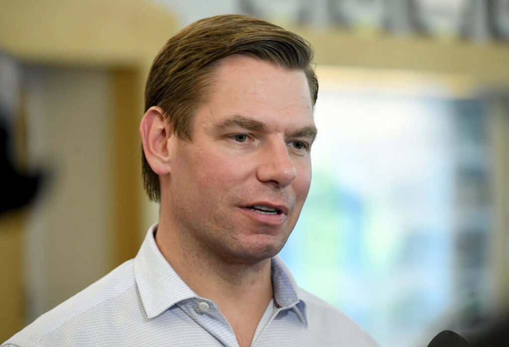Eric Swalwell close-up in light blue shirt with blurred background professional wallpaper background