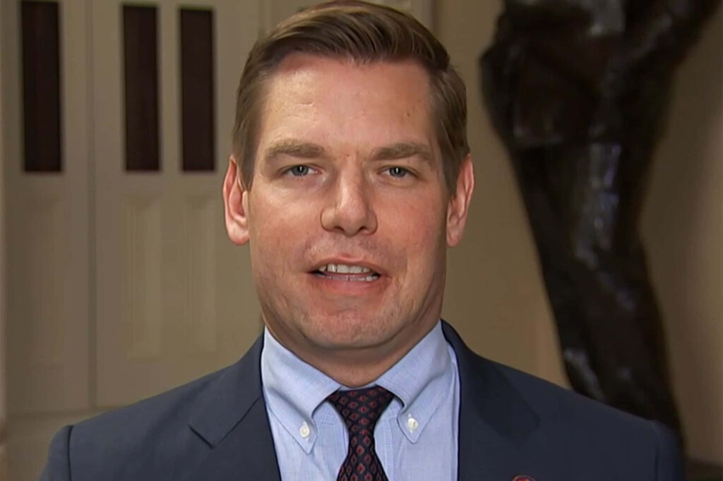 Eric Swalwell in suit and tie formal setting professional wallpaper with soft neutral background