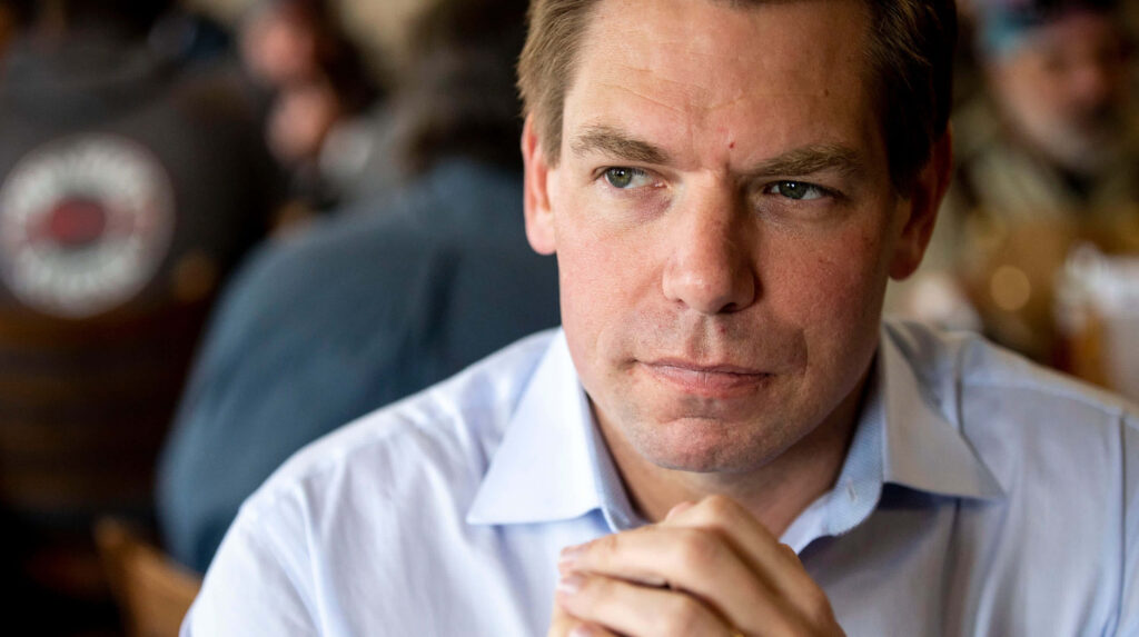Eric Swalwell candid portrait with thoughtful expression soft lighting and blurred casual background Wallpaper