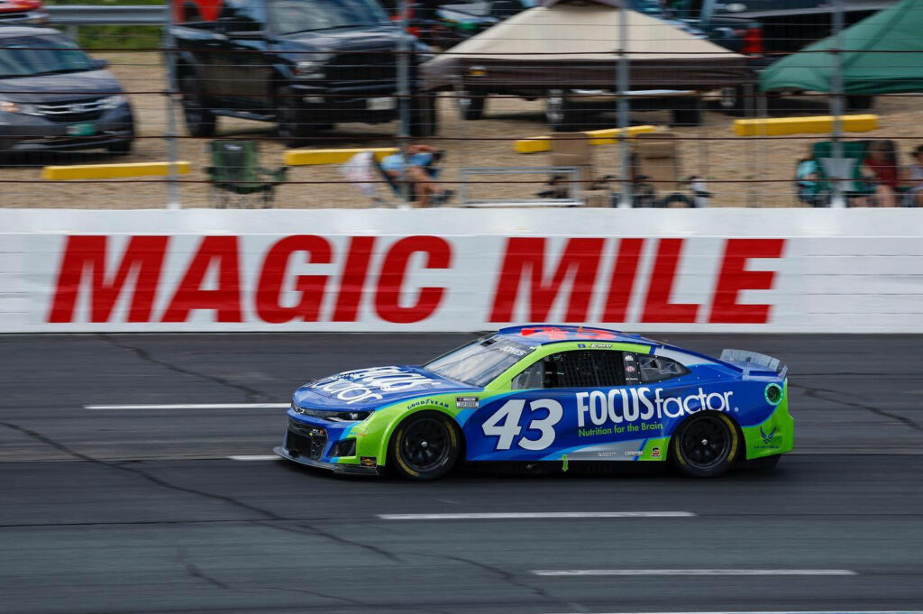 Erik Jones blue 43 FOCUSfactor NASCAR race car speeding on track at Magic Mile action wallpaper