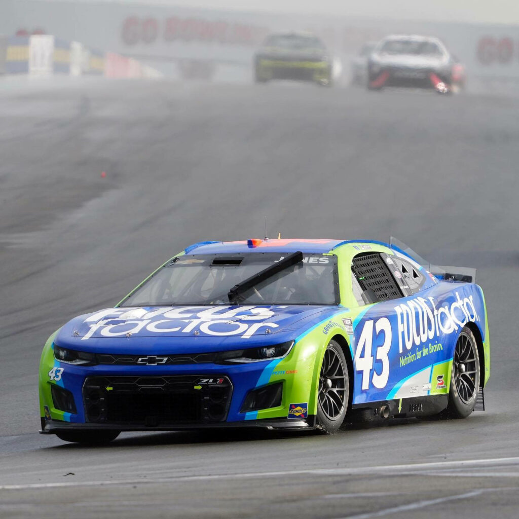 Erik Jones racing No 43 Focus Factor Chevrolet on misty track dynamic Inside The Circuit wallpaper