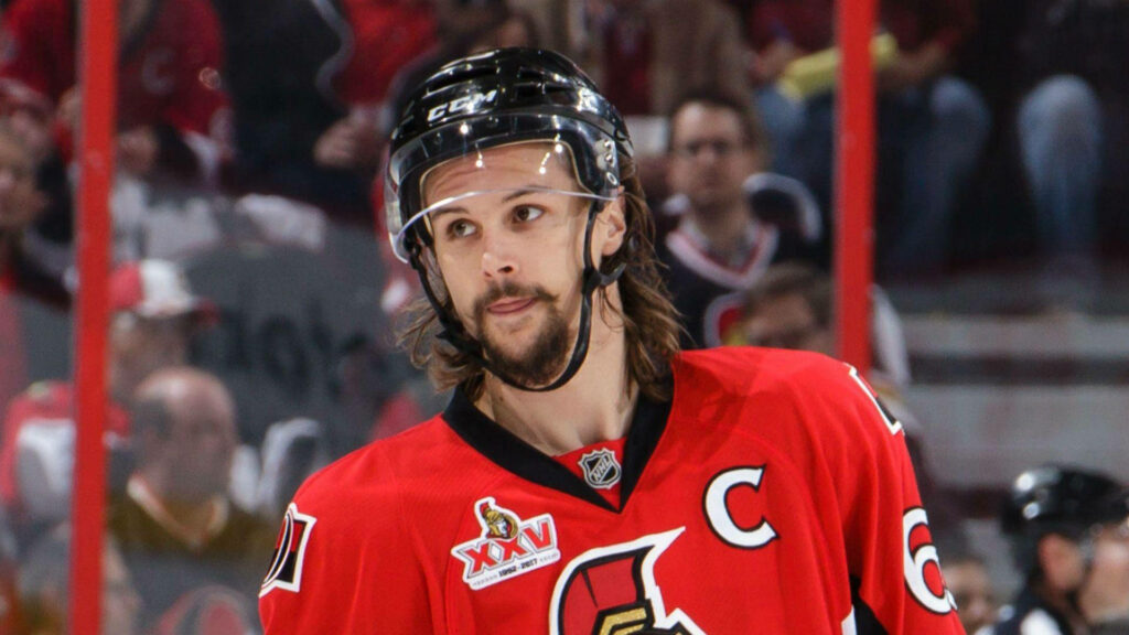 Erik Karlsson Ottawa Senators captain in red jersey focused on ice hockey game action wallpaper