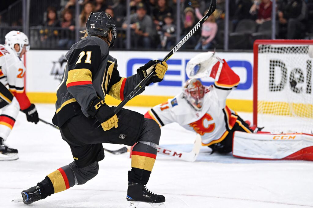 Erik Karlsson Golden Knights dynamic action vs Calgary Flames intense hockey wallpaper background