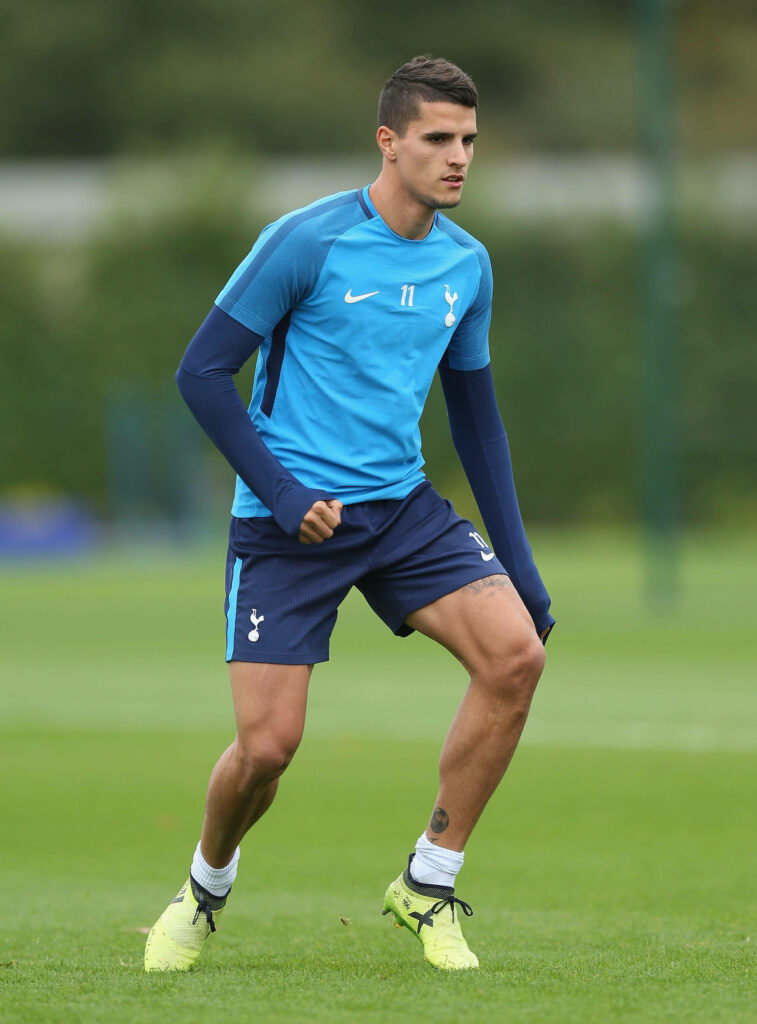Erik Lamela training on field in Tottenham blue kit with green background bright daylight football practice Wallpaper