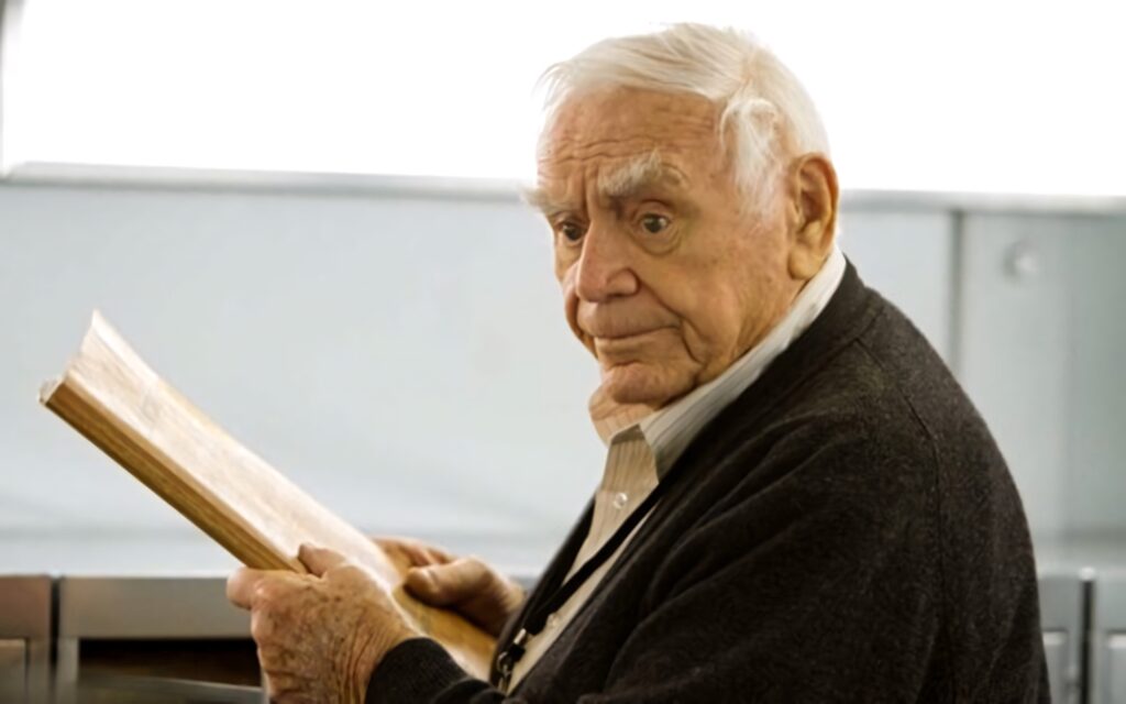Ernest Borgnine candid portrait holding book soft lighting warm intimate actor wallpaper background