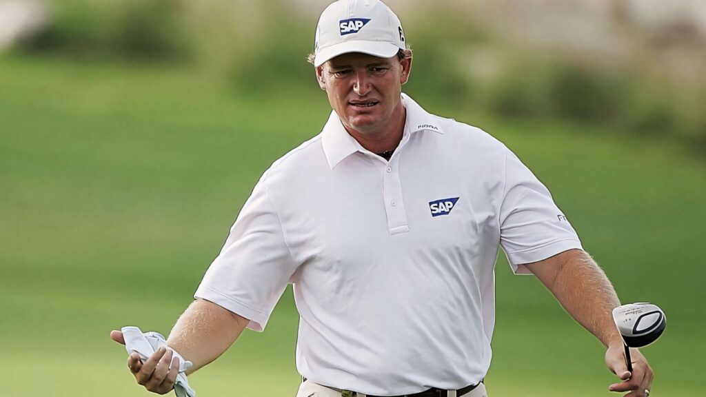 Ernie Els golf wallpaper holding club on green course wearing white SAP polo and cap