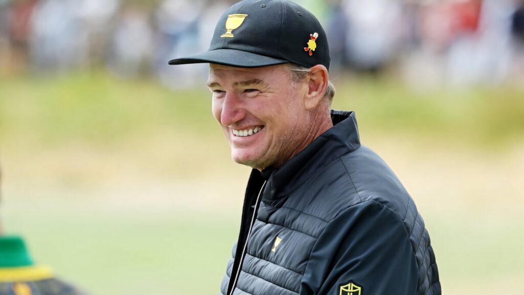 Ernie Els smiling warmly on golf course vibrant natural colors championship energy wallpaper background