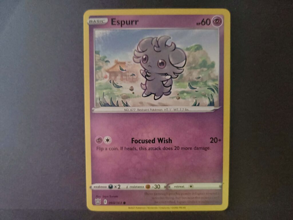 Espurr Pokémon card wallpaper showing Psychic-type Espurr with Focused Wish in pastel landscape