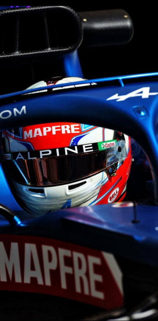 Esteban Ocon in Alpine F1 car cockpit showing vivid blue red colors and racing helmet detail Wallpaper