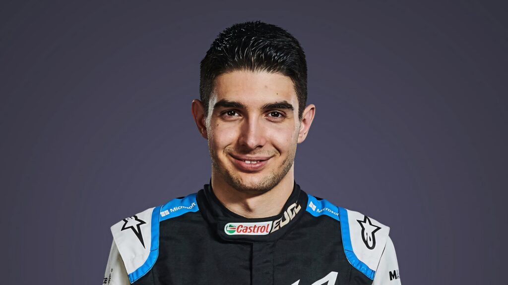 Esteban Ocon Formula 1 driver portrait in racing suit with minimalist gradient background wallpaper