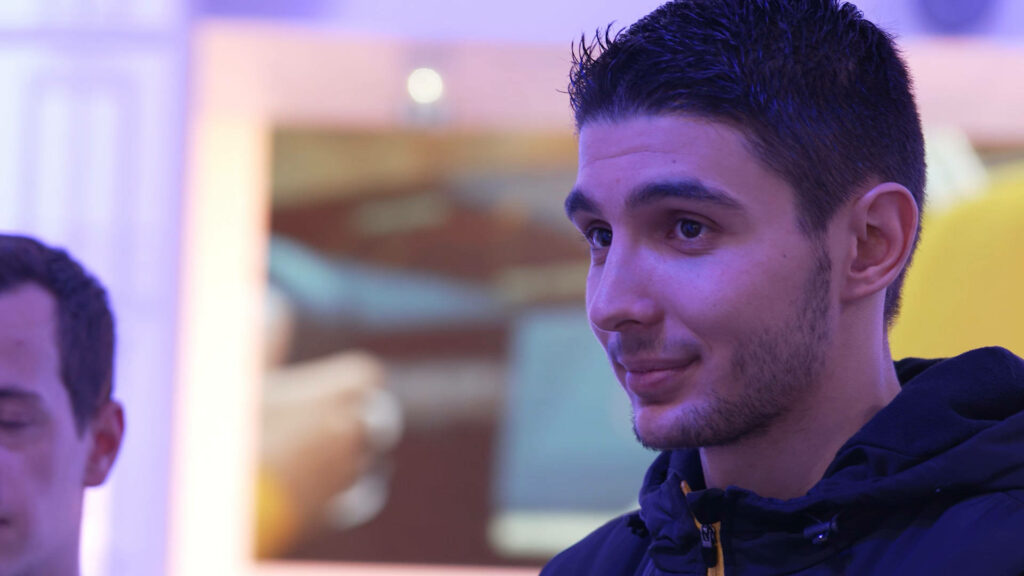 Esteban Ocon close-up F1 driver portrait blue purple tones blurred background wallpaper