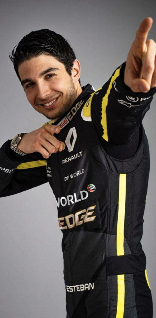 Esteban Ocon in Renault F1 racing suit bold black yellow colors dynamic confident pose Wallpaper
