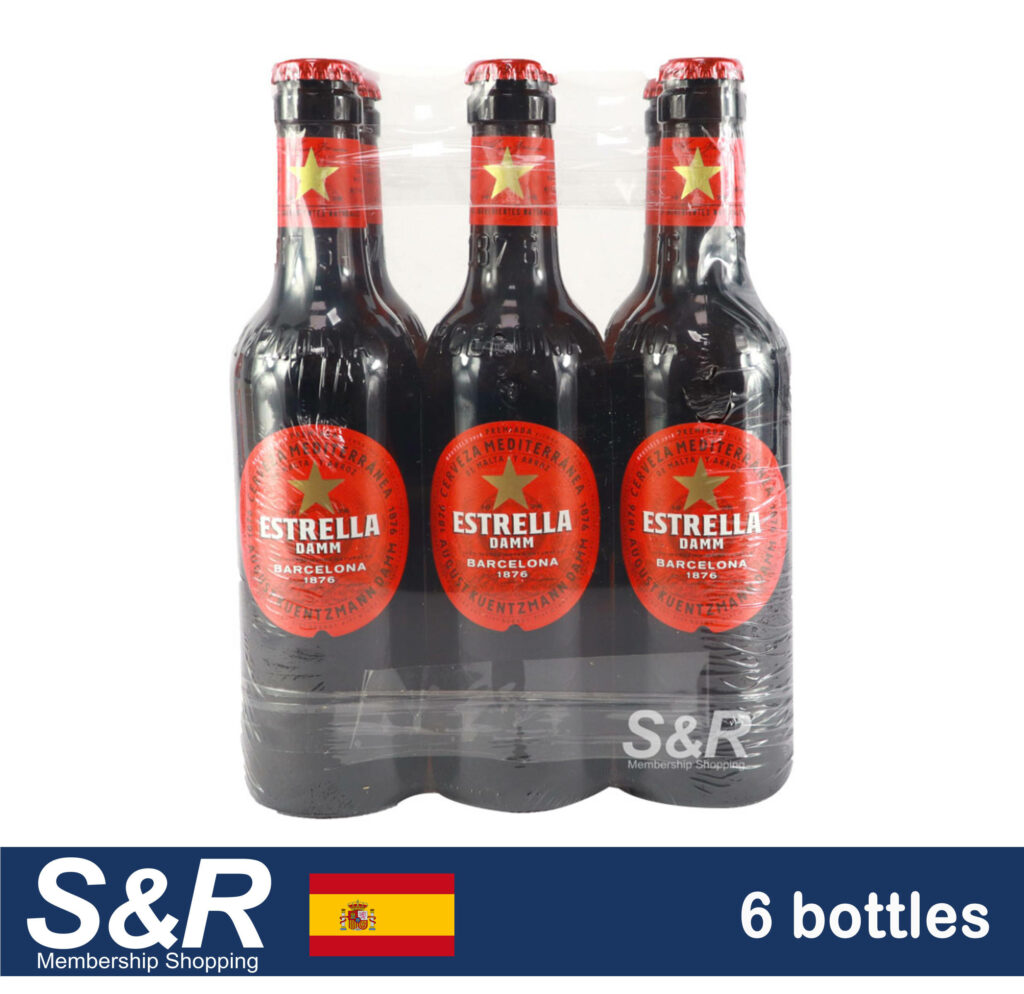Six-pack of Estrella Damm beer bottles with red gold labels on dark brown glass wallpaper background