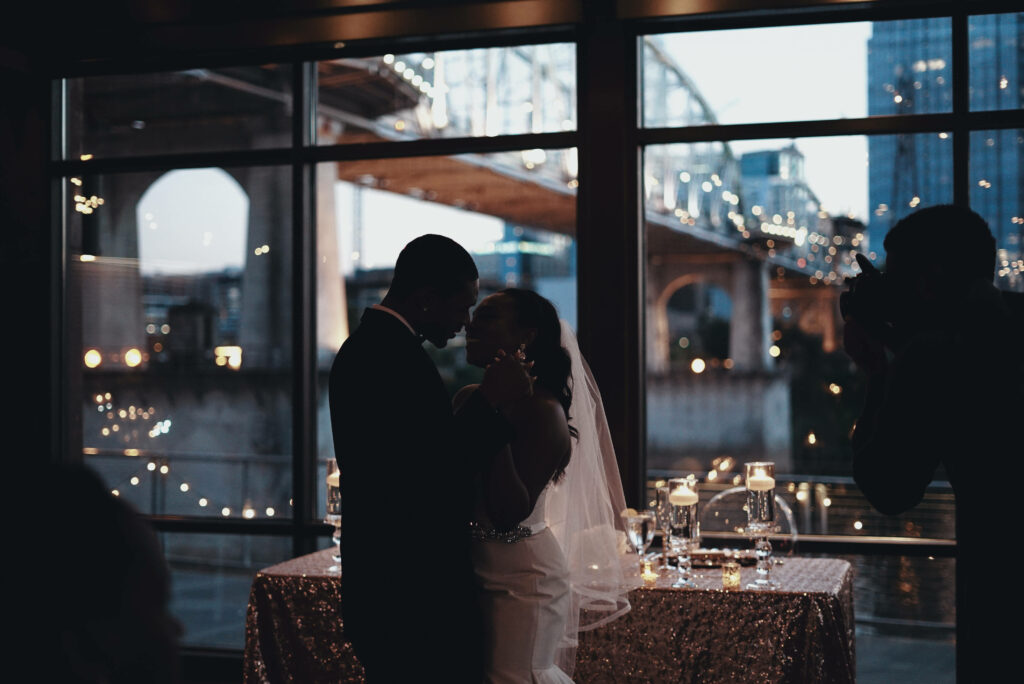 Dance of Eternal Love: An Enchanting Portrait of Newlyweds Embracing Amidst a Serene Black Love Setting Wallpaper