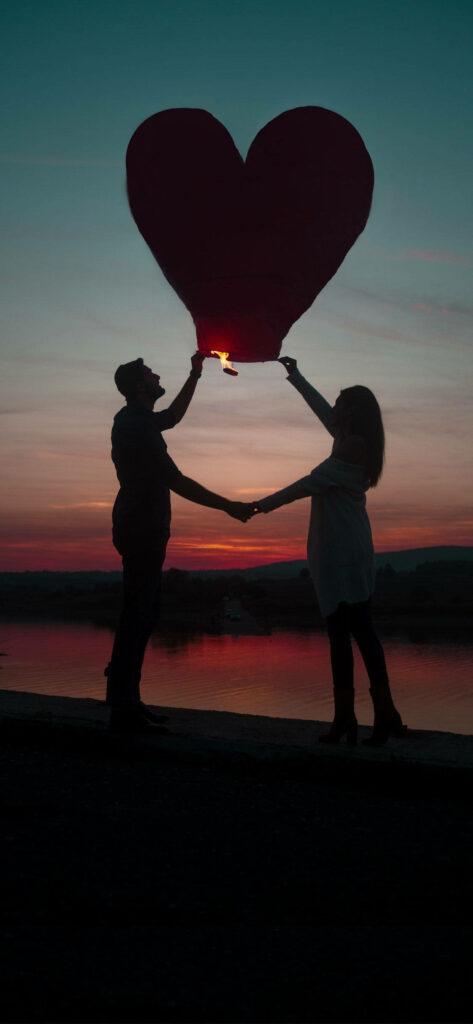 Flying Heart Lanterns: Symbolic Journey of Love Wallpaper