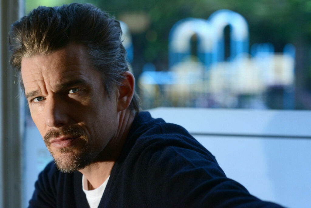 Ethan Hawke contemplative portrait in soft natural light with cinematic cool tones outdoor background Wallpaper