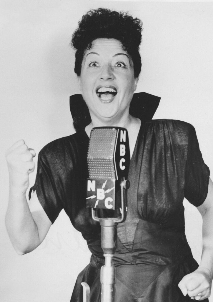 Ethel Merman singing into vintage NBC microphone 1940s classic Hollywood radio performance energy Wallpaper
