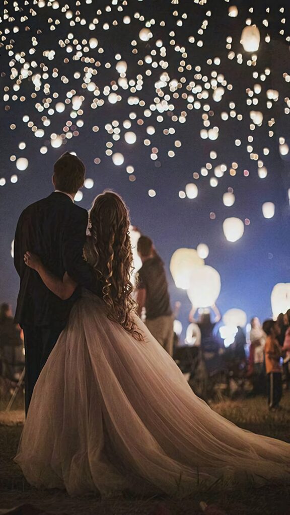 Ethereal bride at sunset with golden hues elegant gown flowing hair magical lanterns wedding wallpaper
